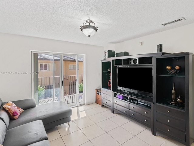 living room with light tile patterned floors and a textured ceiling