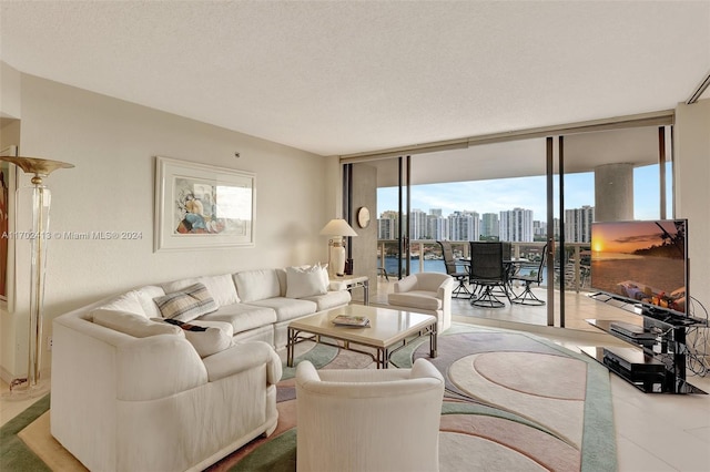 living room with floor to ceiling windows, wood-type flooring, and a textured ceiling