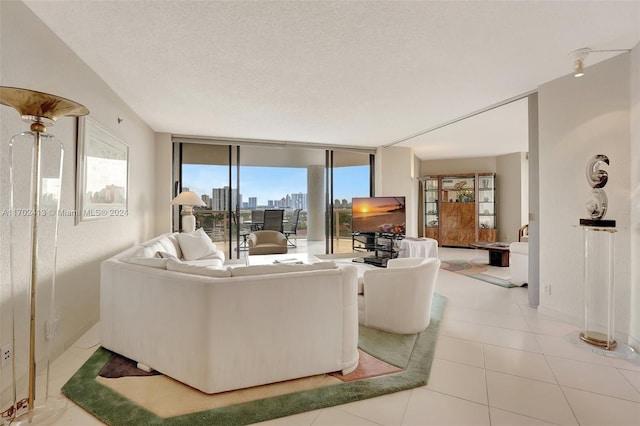 living room featuring light tile patterned floors and a textured ceiling