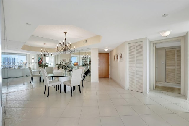 dining space featuring light tile patterned flooring and a chandelier