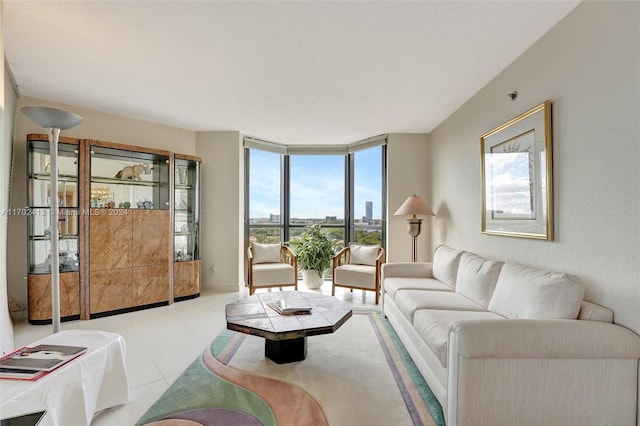 tiled living room featuring floor to ceiling windows