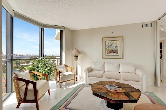 tiled living room with a wall of windows and a textured ceiling