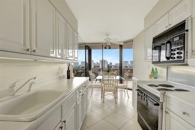 kitchen with range with electric cooktop, white cabinetry, and sink