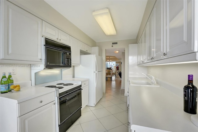 kitchen with white cabinetry, sink, light tile patterned floors, and black appliances