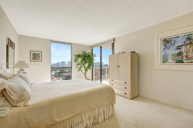 bedroom featuring light colored carpet and a textured ceiling