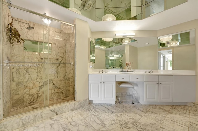 bathroom featuring vanity and a shower with door