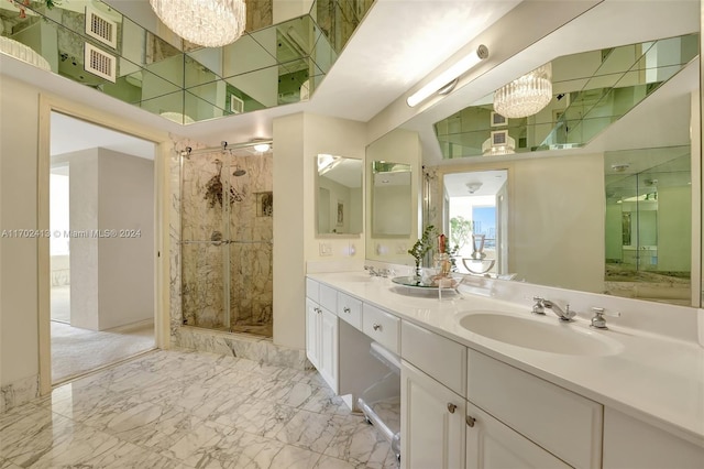 bathroom featuring vanity, a shower with door, and a notable chandelier