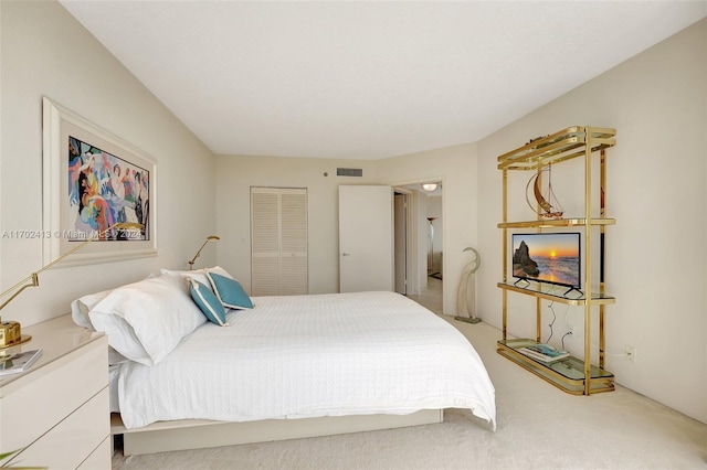 bedroom with a closet and light colored carpet