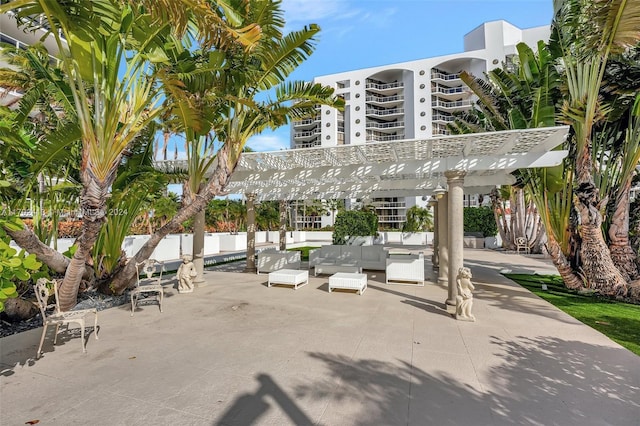 view of property's community featuring outdoor lounge area, a pergola, and a patio