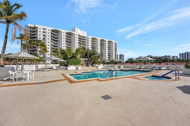 view of swimming pool with a patio and a hot tub