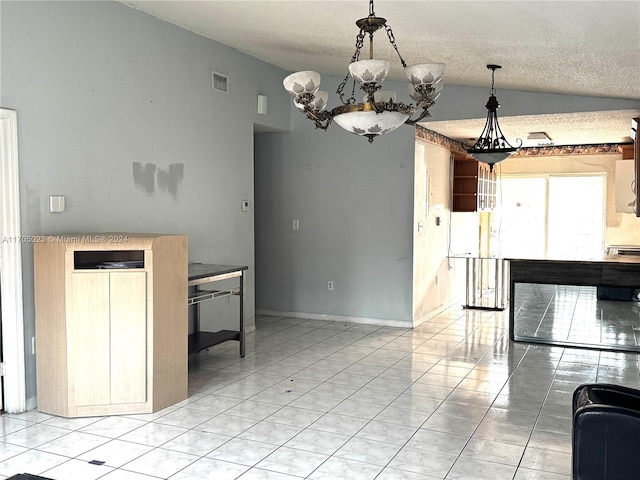 kitchen with vaulted ceiling, light tile patterned floors, a textured ceiling, and an inviting chandelier