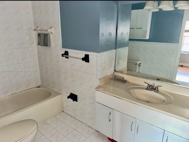 bathroom featuring tile patterned floors, vanity, toilet, and tile walls