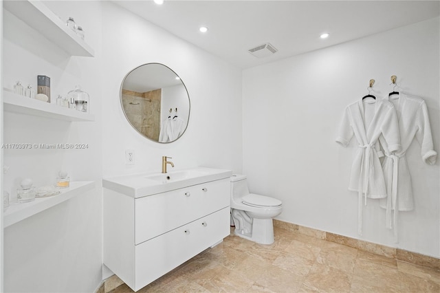 bathroom featuring vanity, toilet, and walk in shower