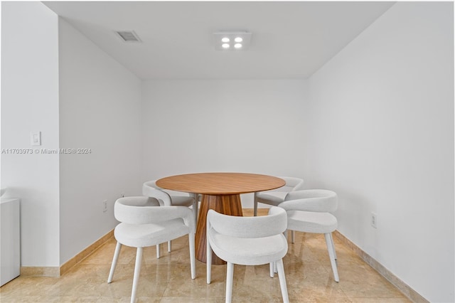 dining area with light tile patterned floors