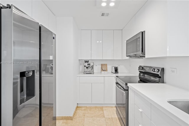 kitchen with white cabinetry and appliances with stainless steel finishes