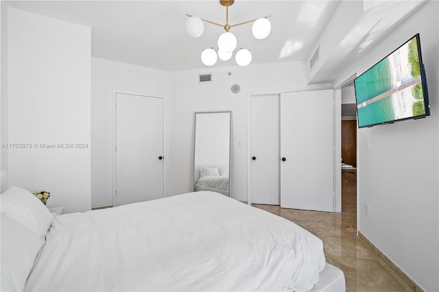 bedroom featuring a notable chandelier