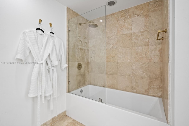 bathroom featuring bath / shower combo with glass door