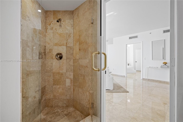 bathroom with a shower with door