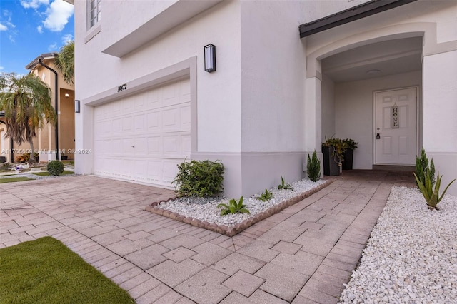 view of exterior entry featuring a garage