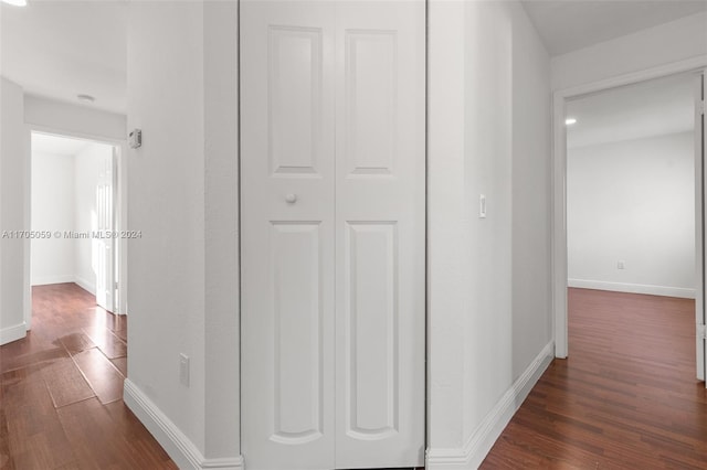 corridor featuring dark hardwood / wood-style flooring