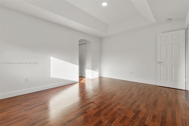 empty room featuring dark wood-type flooring