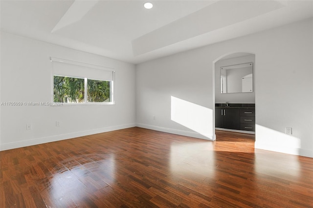 unfurnished room with dark hardwood / wood-style floors