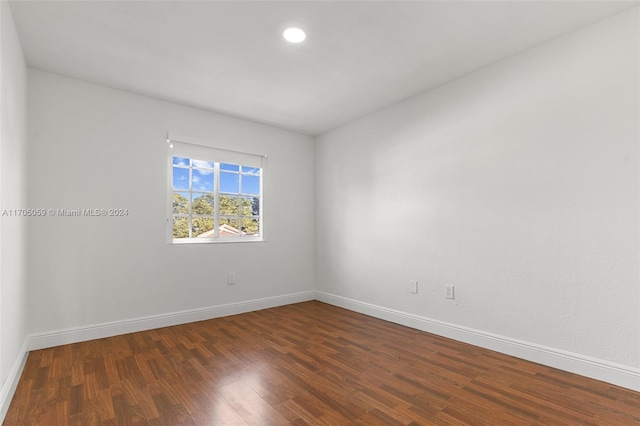 unfurnished room with dark hardwood / wood-style floors