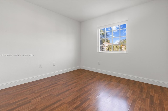 spare room featuring dark hardwood / wood-style flooring