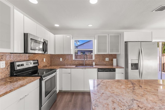 kitchen with white cabinets, dark hardwood / wood-style flooring, sink, and stainless steel appliances