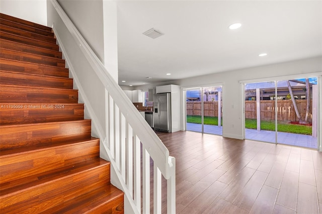 staircase featuring wood-type flooring