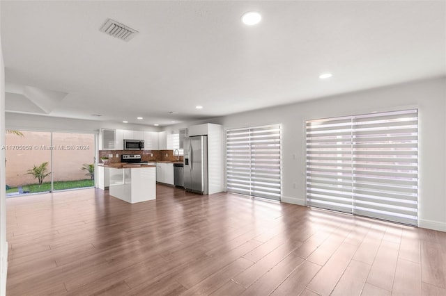 unfurnished living room with light hardwood / wood-style floors