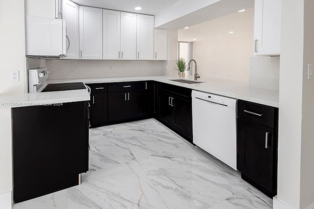 kitchen with white cabinets, white appliances, kitchen peninsula, and sink