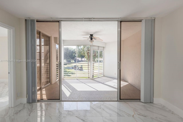 doorway featuring ceiling fan