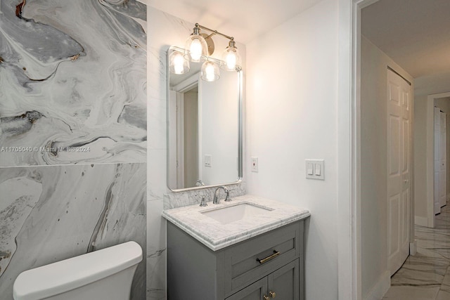 bathroom featuring vanity and toilet