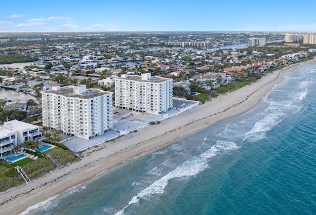 birds eye view of property with a view of the beach and a water view