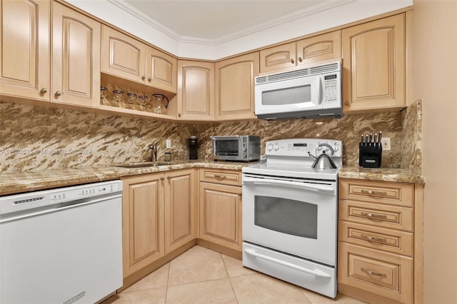 kitchen featuring sink, crown molding, white appliances, light brown cabinetry, and light tile patterned floors