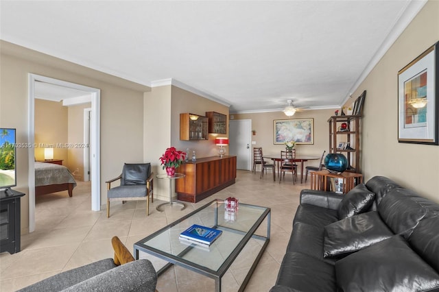 living room featuring ceiling fan, light tile patterned flooring, and crown molding