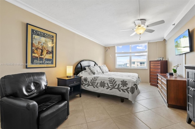 bedroom with ceiling fan, crown molding, light tile patterned floors, and a textured ceiling