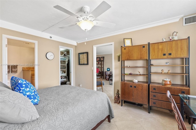 tiled bedroom with crown molding, ceiling fan, a closet, and a spacious closet