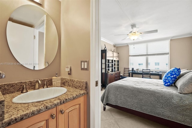 bedroom with crown molding, sink, ceiling fan, and light tile patterned floors