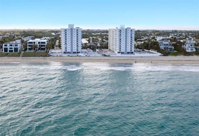 birds eye view of property with a water view and a view of the beach