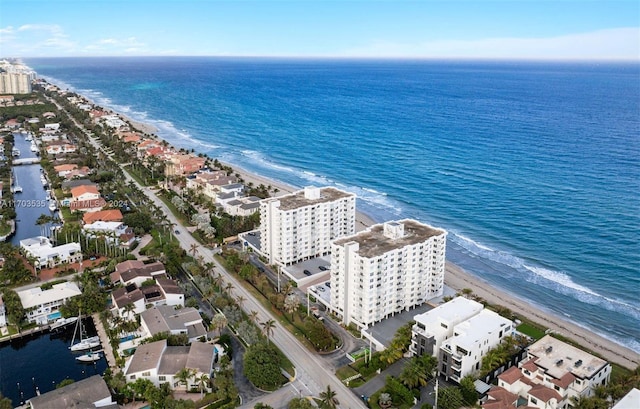 drone / aerial view featuring a water view and a view of the beach