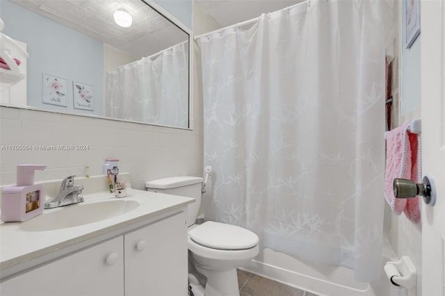 full bathroom featuring shower / bath combination with curtain, vanity, tile walls, tile patterned flooring, and toilet