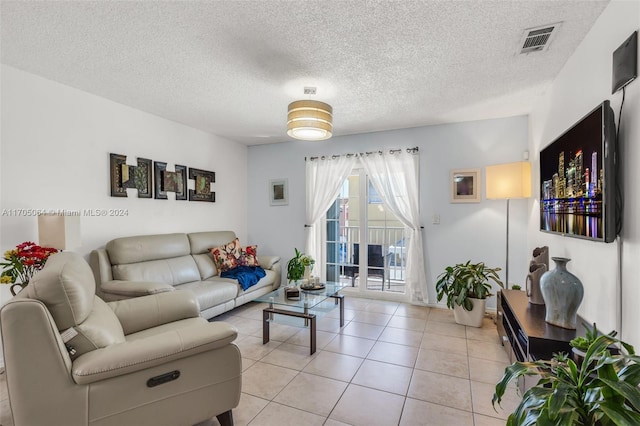 tiled living room featuring a textured ceiling