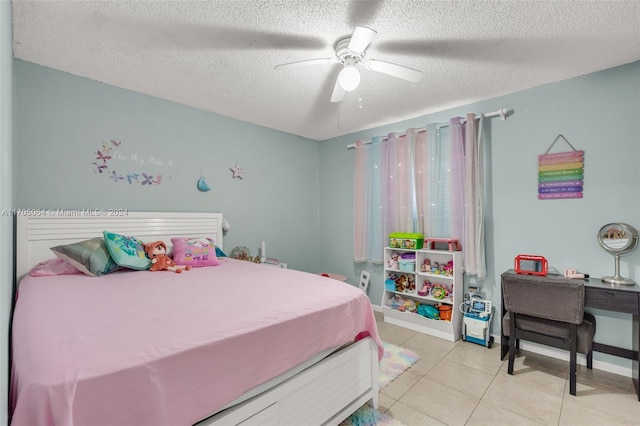 tiled bedroom with ceiling fan and a textured ceiling