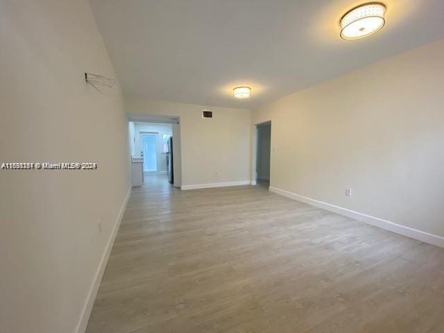 unfurnished room with light wood-type flooring