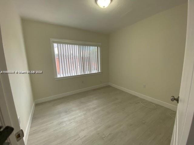 unfurnished room featuring light hardwood / wood-style floors