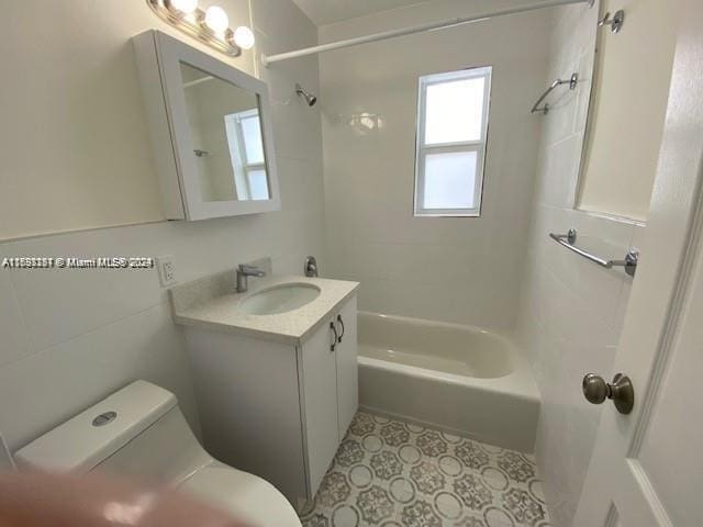 full bathroom featuring vanity, toilet, and tiled shower / bath combo