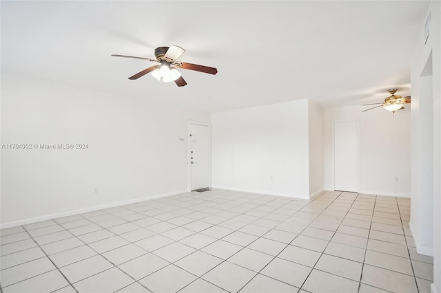 tiled empty room with ceiling fan