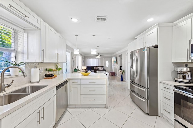 kitchen featuring appliances with stainless steel finishes, white cabinetry, ceiling fan, and sink